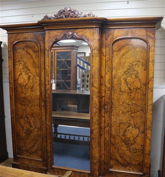 A Victorian figured walnut breakfront wardrobe with central mirror